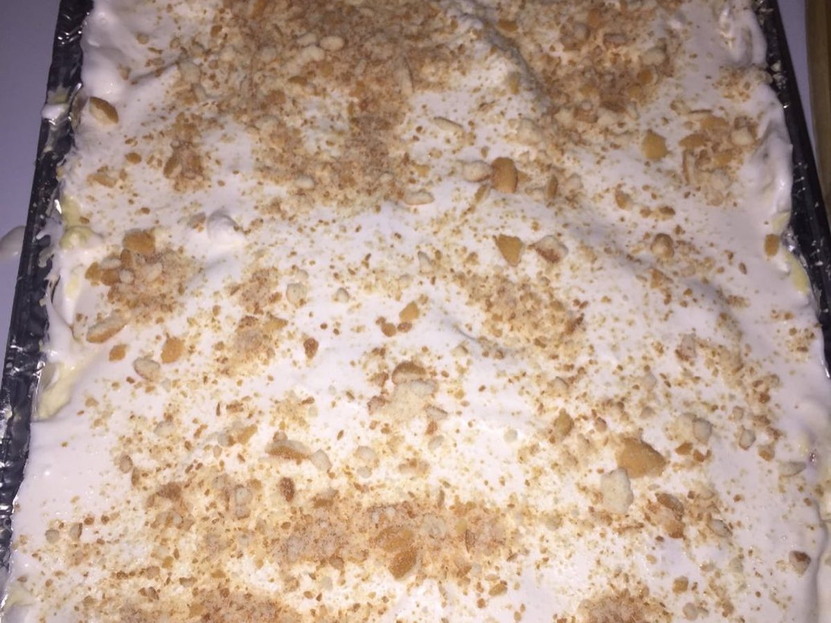 A tray of banana pudding topped with crushed vanilla wafers