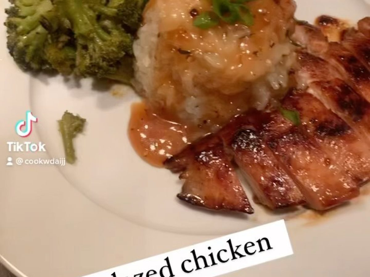 Glazed chicken with broccoli and rice on a white plate