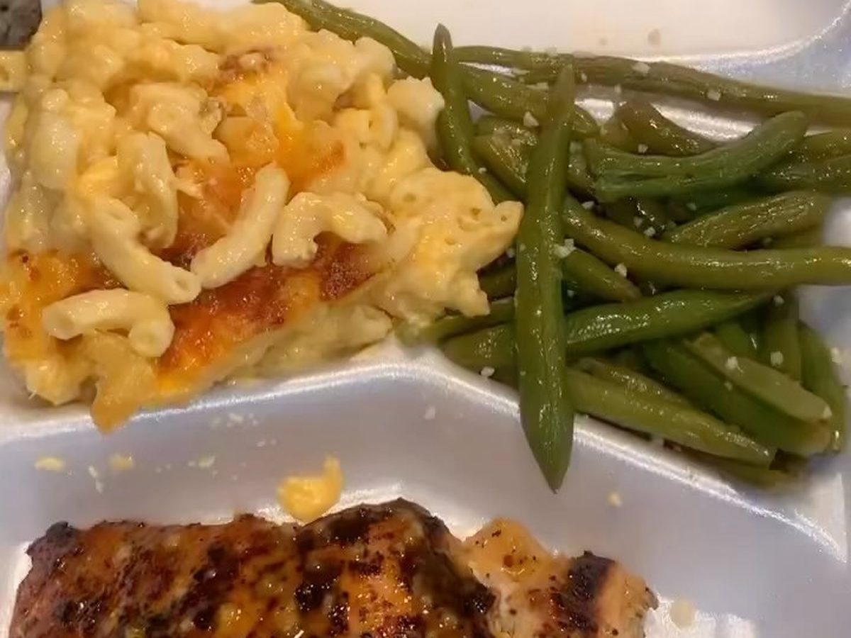 Fried chicken cutlet with baked mac and cheese and green beans on a white plate