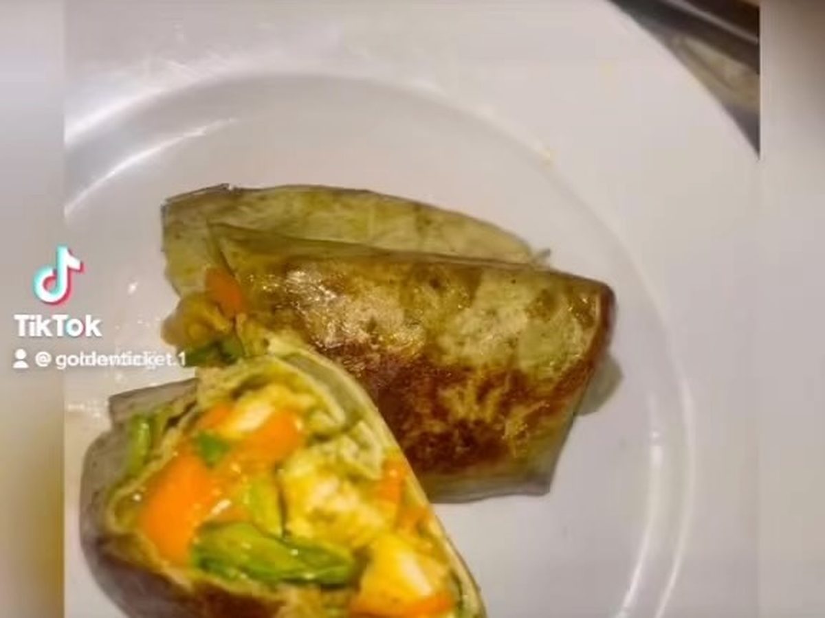 Halved peppers stuffed with shrimp and risotto on a white plate